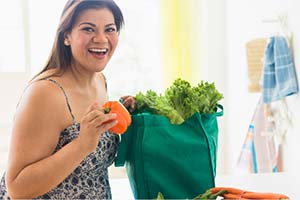 Person carrying fresh grocery produce