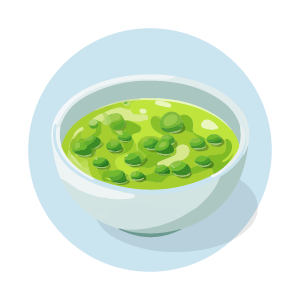 Green pea soup in white bowl